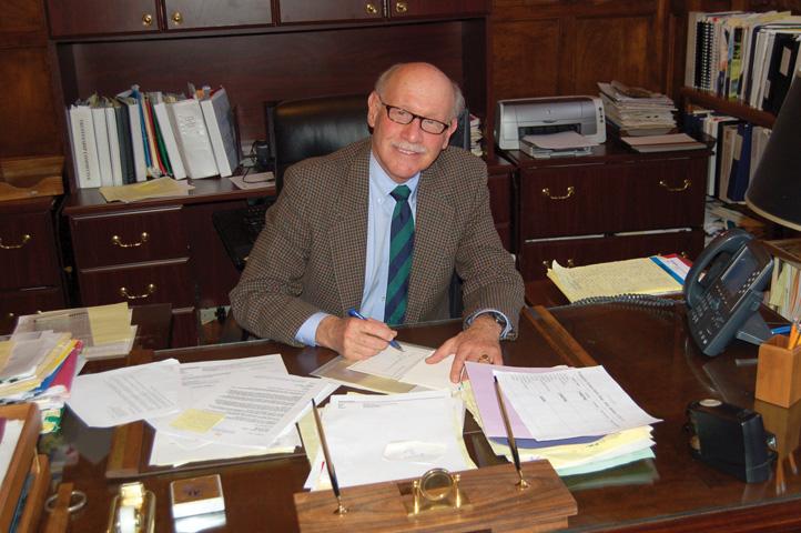 President Michael A. MacDowell poses for a photo in his Mercy Hall office.