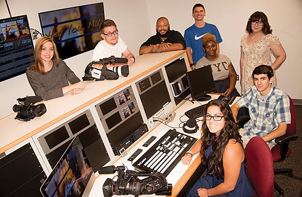 Staff members of MCN 87 pose for a picture in the stations control room in McCauley-Walsh Hall. 