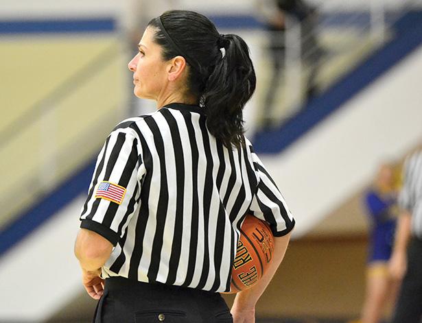 A ref waits at a basketball game. 