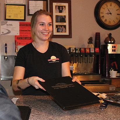 Senior communications major Erin Dougherty working at III Guys Restaurant and Sports Bar. 