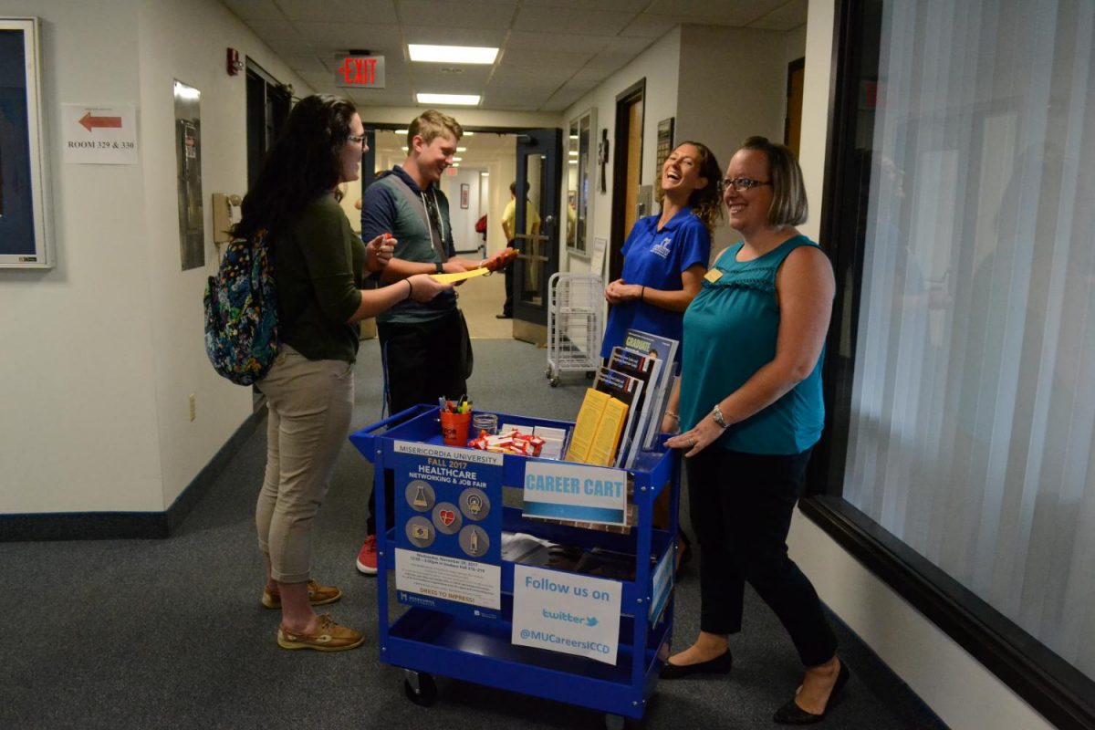 From right to left: Tiffany Wiernusz, Coordinator of Career Development, Bernie Rushmer, Director of Insalaco Center for Career Development (ICCD), and two students interact with the ICCDs pop-up career cart on Mercy Halls third floor.