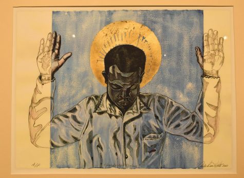 A piece titled “Hands Up-Nimbus” by Curlee Raven Holton, who helped curate “The Fine Print” exhibit, hangs in the Pauly Friedman Art Gallery. Holton created it to bring awareness to bring more awareness to the discrimination faced by Black people. 