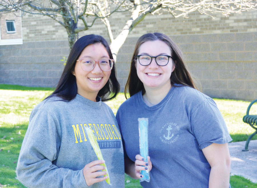 Mikayla Kalitis (Sophomore, Computer Science) and Emma Polle (Junior, Healthcare Management) enjoy freeze pops at the backyard party.