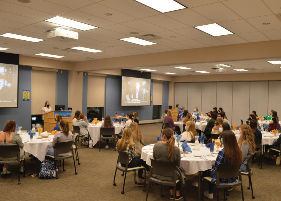 Tiffany Wiernusz explains to the students proper dining etiquette and networking skills during a free workshop.