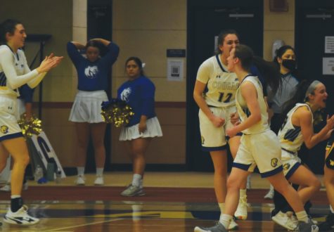 The Misericordia Women’s Basketball team celebrate their victory on the court, with an 8
point lead and only seconds left in the game.