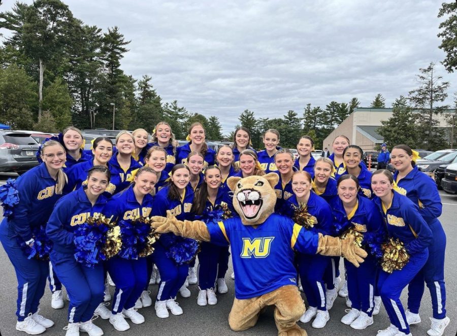 The+Misericordia+Cheer+Team+poses+with+Archie+during+the+2022+Homecoming+Tailgate