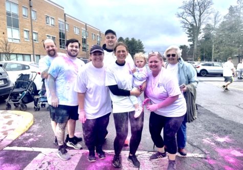 Dr. Evans and her family pose for a family photo after the 5k race,
covered in color and happy the event was successful.