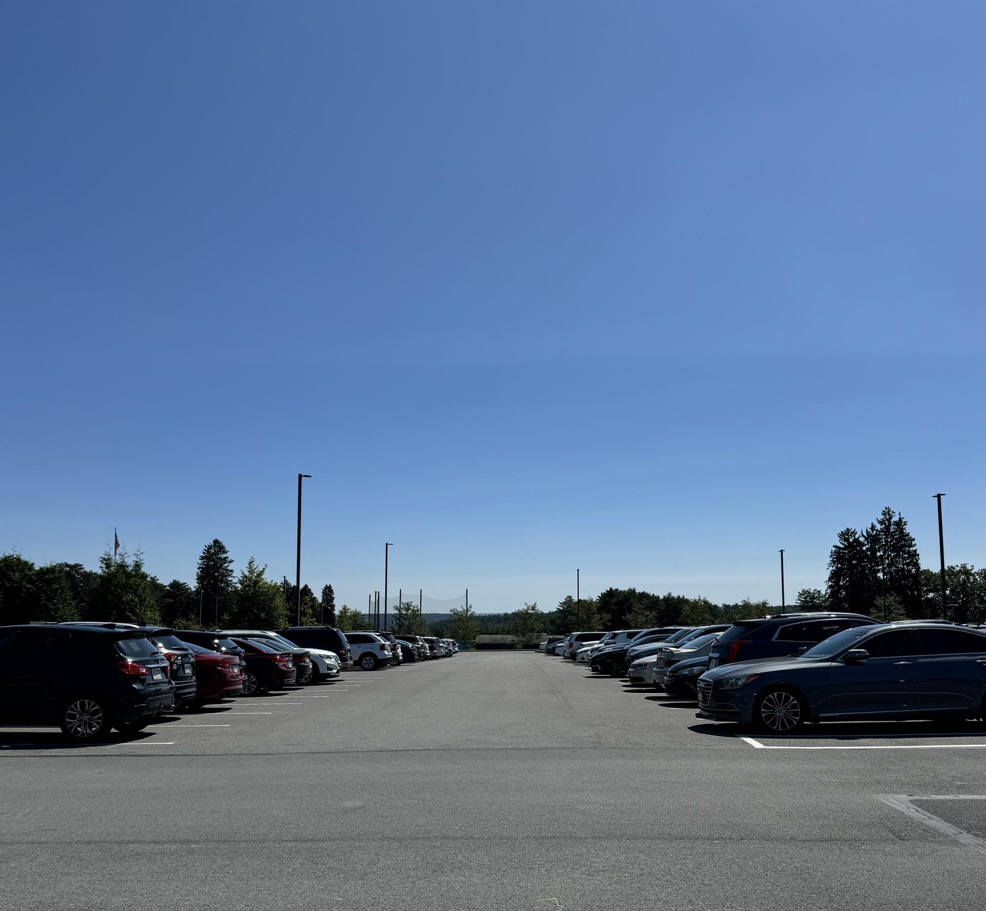 A wide view of Misericordia University's parking lot during a busy school day.