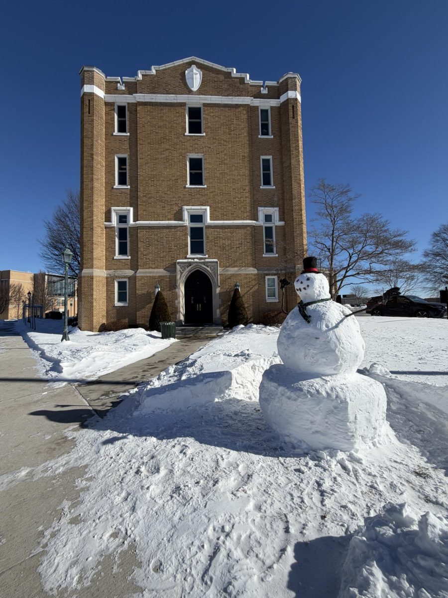 A snowman chills outside Mercy Hall. 